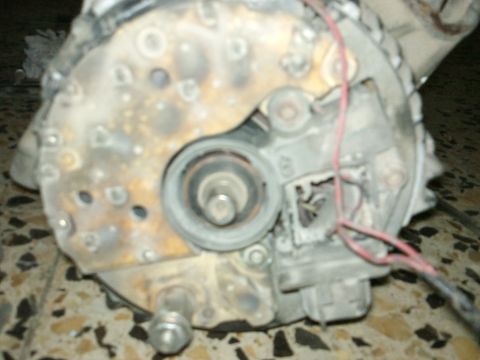 1998 Ford Crown Victoria - This is a close-up view of a used alternator, showing its internal components and wiring.