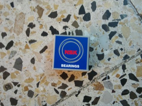 1998 Ford Crown Victoria - A box of NSK bearings rests on a speckled floor.
