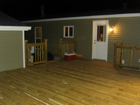 2007 Ford Mustang - A nighttime view of a wooden deck with a house in the background.
