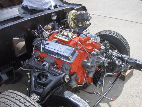 1970 Chevrolet Camaro - Engine assembly, likely for a 1970 Chevrolet, shown with orange block and chrome valve covers.