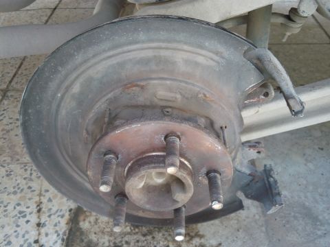 1998 Ford Crown Victoria - Close-up of a rear brake rotor and hub assembly, consistent with a 1998 Ford Crown Victoria.