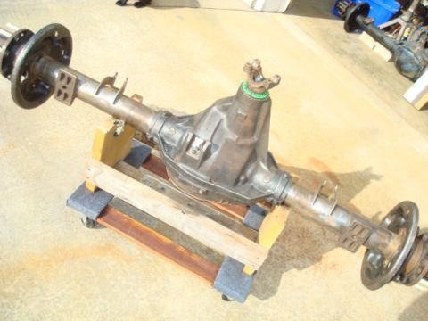 1995 Ford Bronco - Rear axle assembly, likely for a truck or SUV, resting on a makeshift stand.