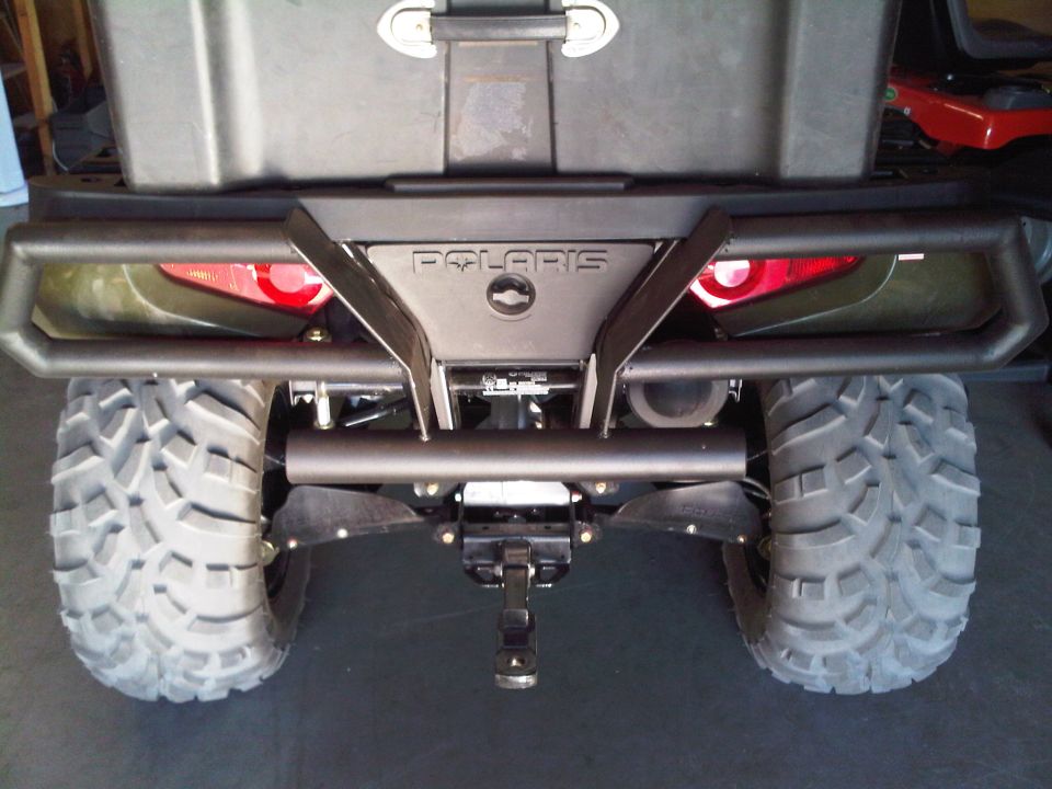 ATV rear view with large knobby tires, black bumper, and Polaris logo