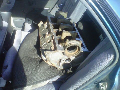 1994 Ford F-150 - Engine block is placed on padding in the back seat of a vehicle.
