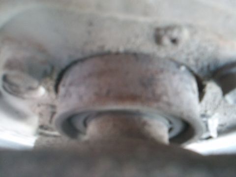 1998 Ford Crown Victoria - A blurry close-up shows a vehicle's suspension component, possibly related to the e-brake.
