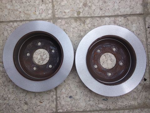 1998 Ford Crown Victoria - Pair of brake rotors shown before installation. Supermotors.net branding is present.