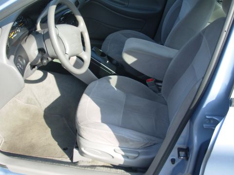 1997 Ford Taurus - Interior view of a 1997 Ford Taurus, showing the front seats, steering wheel, and dashboard.