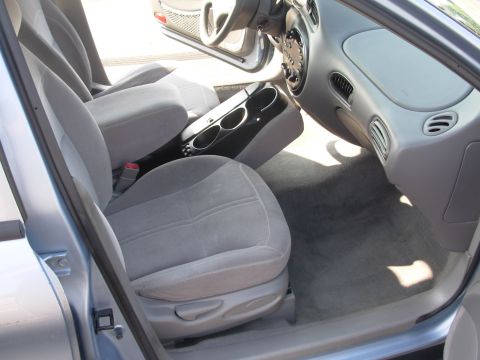 1997 Ford Taurus - The interior of a 1997 Ford Taurus features gray cloth seats and a center console with cup holders.