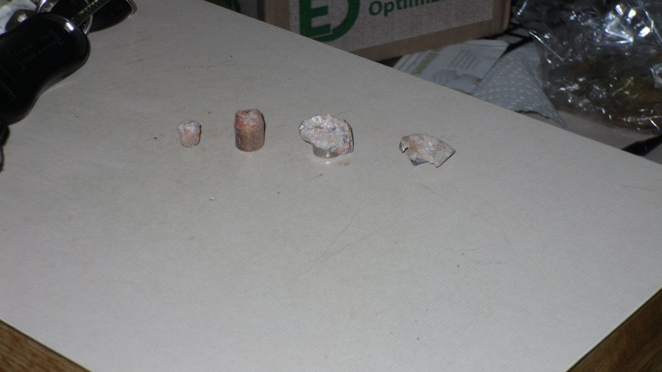 flashlight pointed at four small rocks on a table