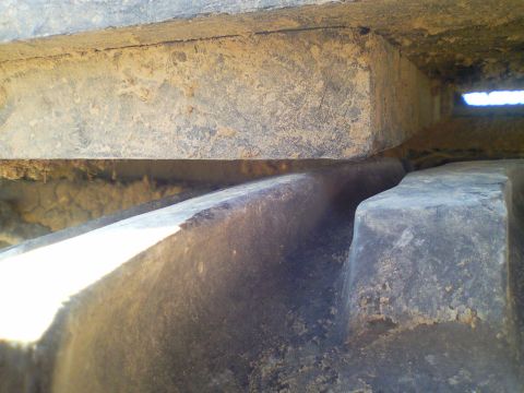 1989 Ford Bronco - A detailed view of a vehicle's tire and suspension components, with visible dirt and wear.
