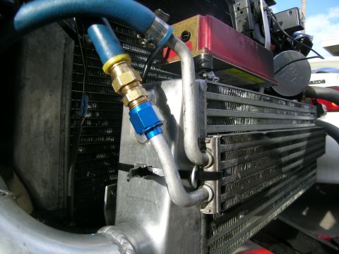 1995 Ford Probe - Close-up of engine bay components, including an intercooler and radiator, with visible plumbing and fittings.