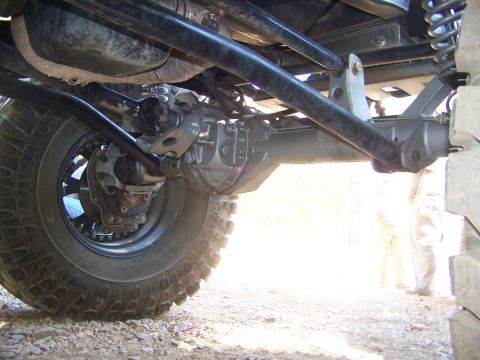1992 Jeep YJ - Close-up of the rear axle assembly and suspension components of an off-road vehicle.