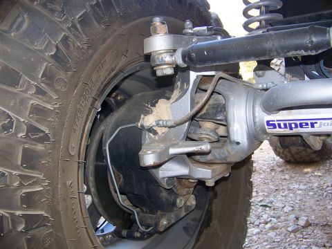 1992 Jeep YJ - Detail of the front suspension and tire assembly on a Jeep, showing aftermarket SuperJoint components.