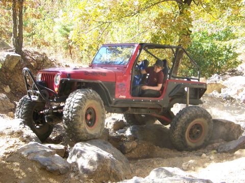 1992 Jeep YJ - This 1992 Jeep YJ is navigating a challenging rocky trail during an off-road excursion.