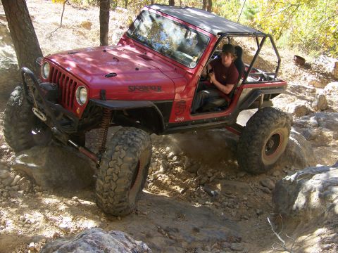 1992 Jeep YJ - This modified Jeep YJ navigates a rocky off-road course, its suspension and tire capabilities.