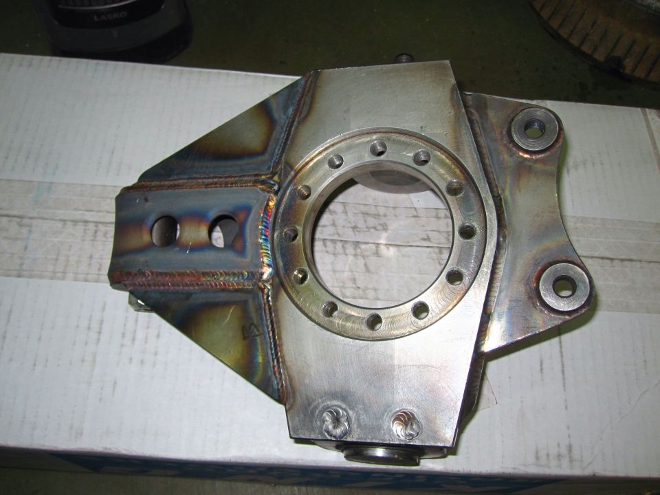 Custom metal spindle assembly with a circular flange and mounting points