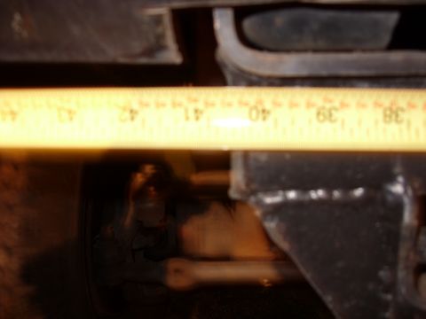 1988 Ford Bronco - A measuring tape is placed over a suspension component, showing measurements from 38 to 43.
