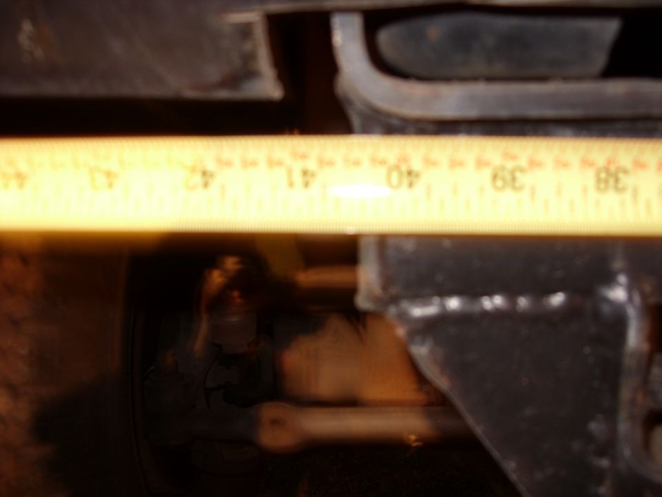 Measuring tape over suspension component