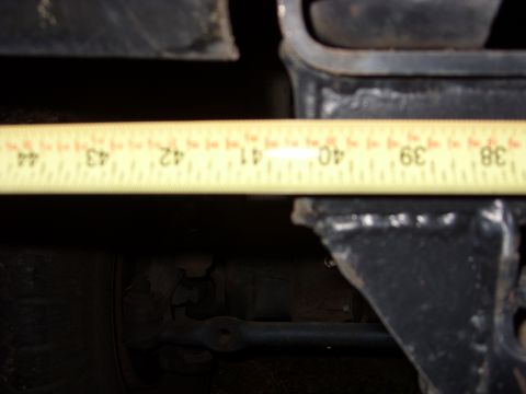 1988 Ford Bronco - Measuring suspension component with a tape measure, showing inches from 40 to 44.
