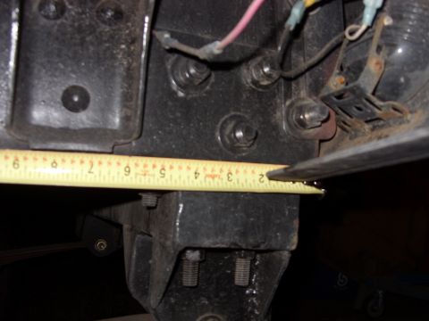 1988 Ford Bronco - Close-up of a black metal component being measured with a yellow tape measure, showing approximately 2 inches.