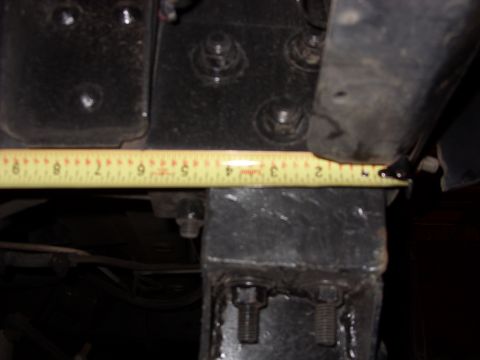 1988 Ford Bronco - Close-up of a metal bracket being measured with a yellow tape measure.