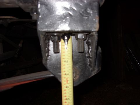 1988 Ford Bronco - Measuring a suspension part with a yellow tape measure. The measurement is between 2 and 3 inches.