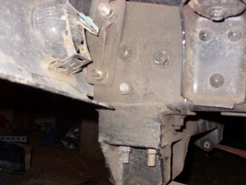 1988 Ford Bronco - Detail shot of a vehicle's frame and suspension mounting points, showing bolts and brackets.