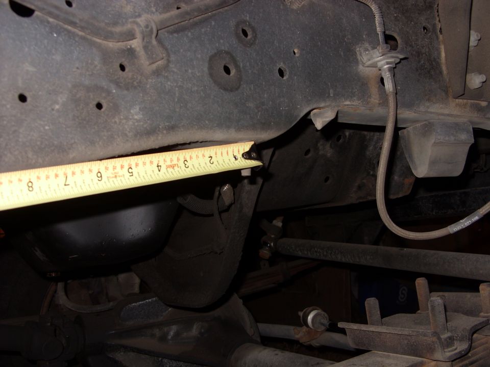 Vehicle frame with a tape measure indicating suspension component size