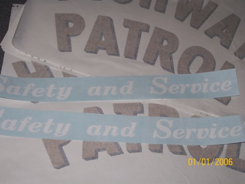 Two light blue decals with white text 'Safety and Service' over larger brown letters that say 'PATROL'