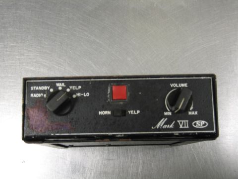 1991 Ford LTD Crown Victoria - A siren control unit labeled 'Mark VII' with various function and volume controls.