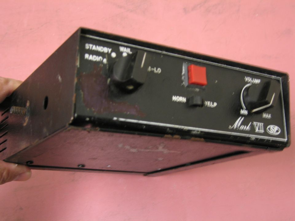 Black audio control unit with knobs and buttons labeled Mark VII