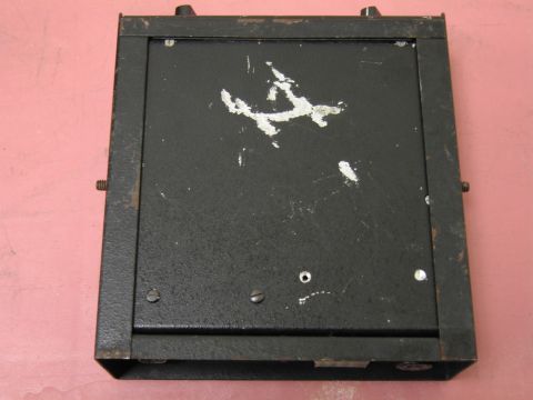 1991 Ford LTD Crown Victoria - A black metal box with visible knobs, screws, and some paint wear is shown from a top-down perspective.