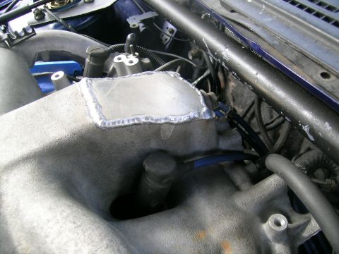 1995 Ford Probe - Custom modification to an engine's intake manifold shows a welded metal plate.