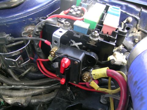 1995 Ford Probe - Close-up view of the engine bay fuse box and associated wiring, including a prominent 100A breaker.