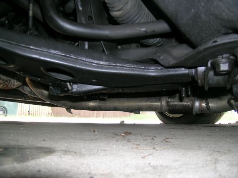1995 Ford Probe - A low-angle view of a car's undercarriage, showing the exhaust system and suspension.