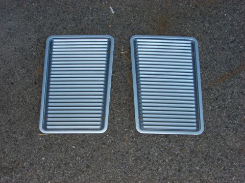 1993 Jeep YJ - Two silver grilles with horizontal slats are shown against a dark, rough surface. The registry claims they are from a 1993 Jeep YJ.
