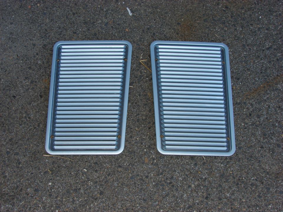 Pair of silver grilles with horizontal slats