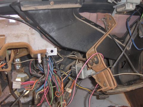1977 Pontiac Trans Am - Vehicle interior shows a complex wiring harness and various mechanical parts under the dashboard.