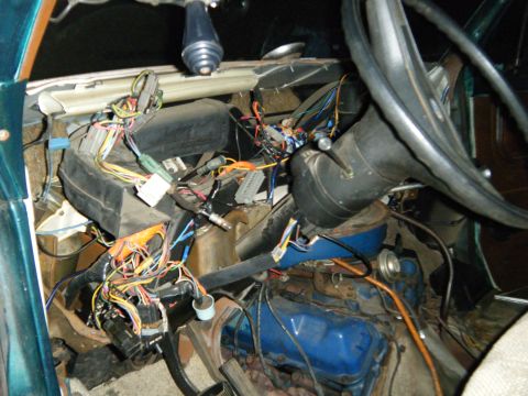 1981 Ford E350 - The interior of a 1981 Ford E350 is visible, with extensive exposed wiring and the steering wheel.