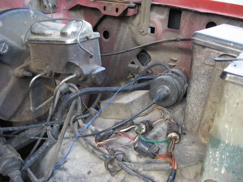 1981 Ford Bronco - Engine bay detail of the driver's-side firewall showing a weathered brake master cylinder and booster with steel brake lines, alongside a r…