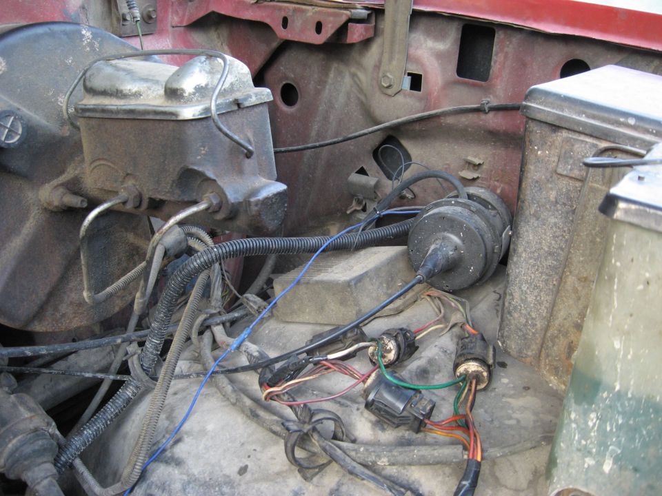 Firewall detail with rusty brake master cylinder, booster, vacuum canister and loose wiring