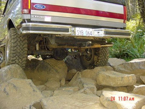 1989 Ford Bronco - 1989 Ford Bronco rear end on a rocky trail. The vehicle has a Roush badge.