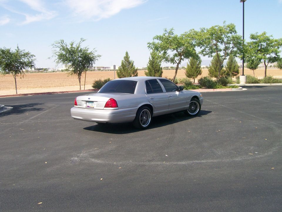 2006 Ford Crown Victoria parked in a lot, rear view