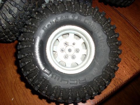 1994 Ford Escort - This image shows a close-up of an off-road tire, identified as ROKLOX 1.9 Comp Tires, with its aggressive tread pattern.