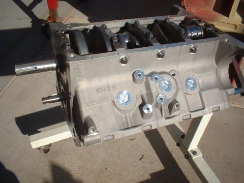 1965 Shelby Cobra - Close-up view of an engine block, showing internal components and casting marks, resting on a portable stand.