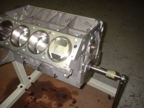 1965 Shelby Cobra - Close-up of an engine block with pistons installed, resting on a stand.