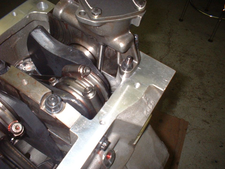 Close-up of engine crankshaft, connecting rods, and bearings within an engine block