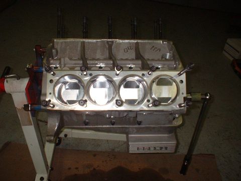 1965 Shelby Cobra - Close-up of an engine block assembly, pistons and cylinder bores, mounted on an engine stand.