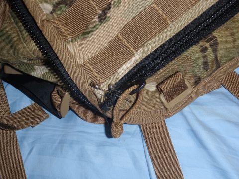 1991 Ford Bronco - A safety pin is used to secure the zipper pull on a piece of camouflage fabric with straps.