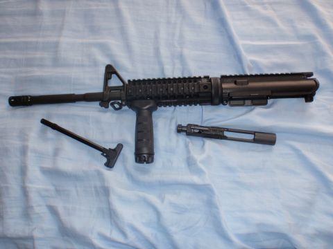 1991 Ford Bronco - Disassembled AR-15 upper receiver with charging handle and bolt carrier group shown on a blue fabric surface.